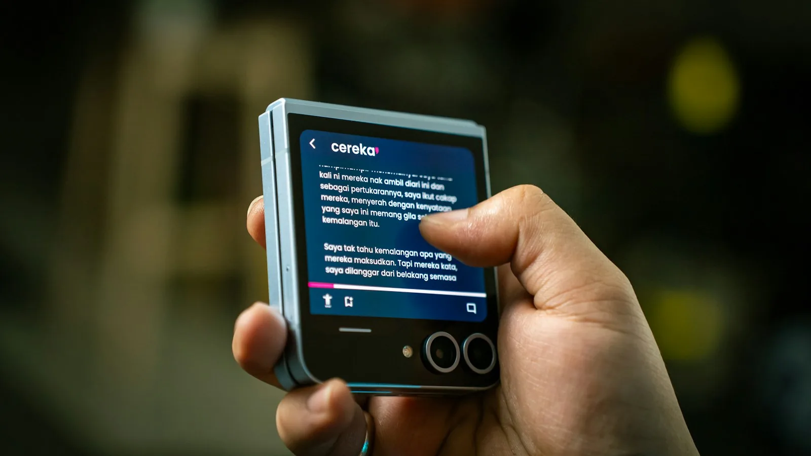 hands holding small digital reading screen
