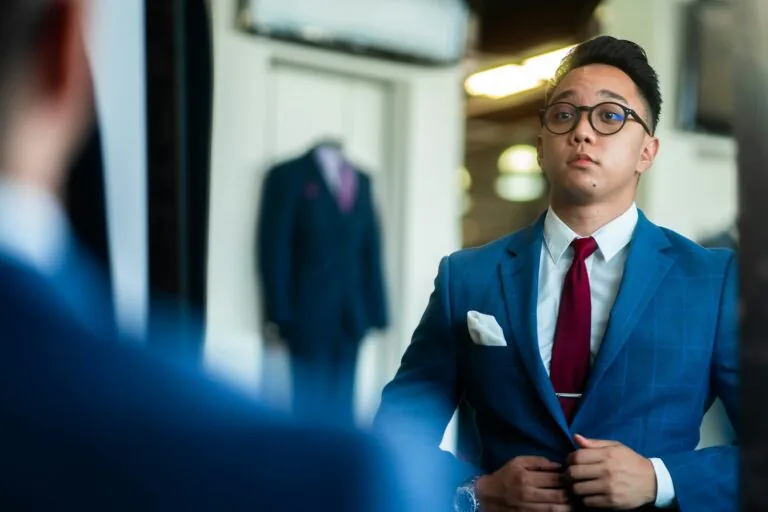man trying on custom suit fitting