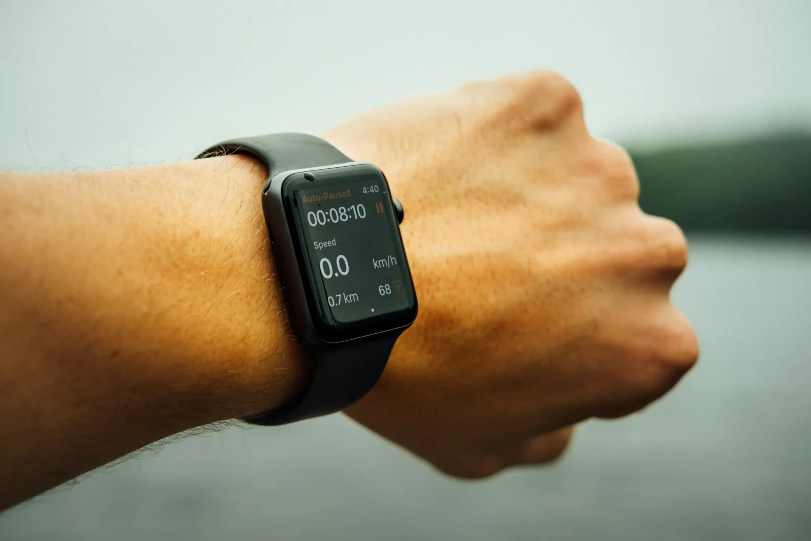 person checking fitness tracker on wrist