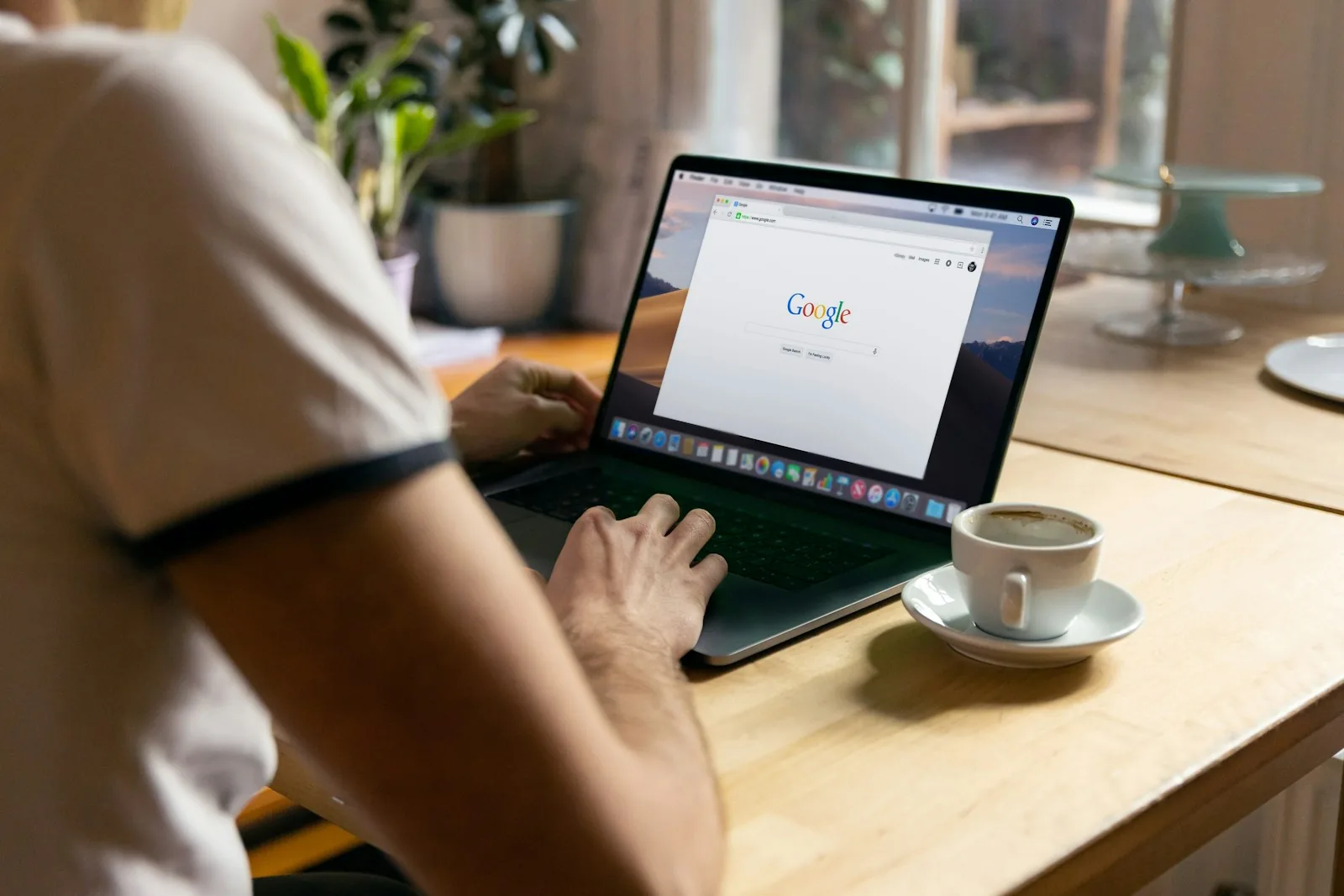 person using Google search on laptop