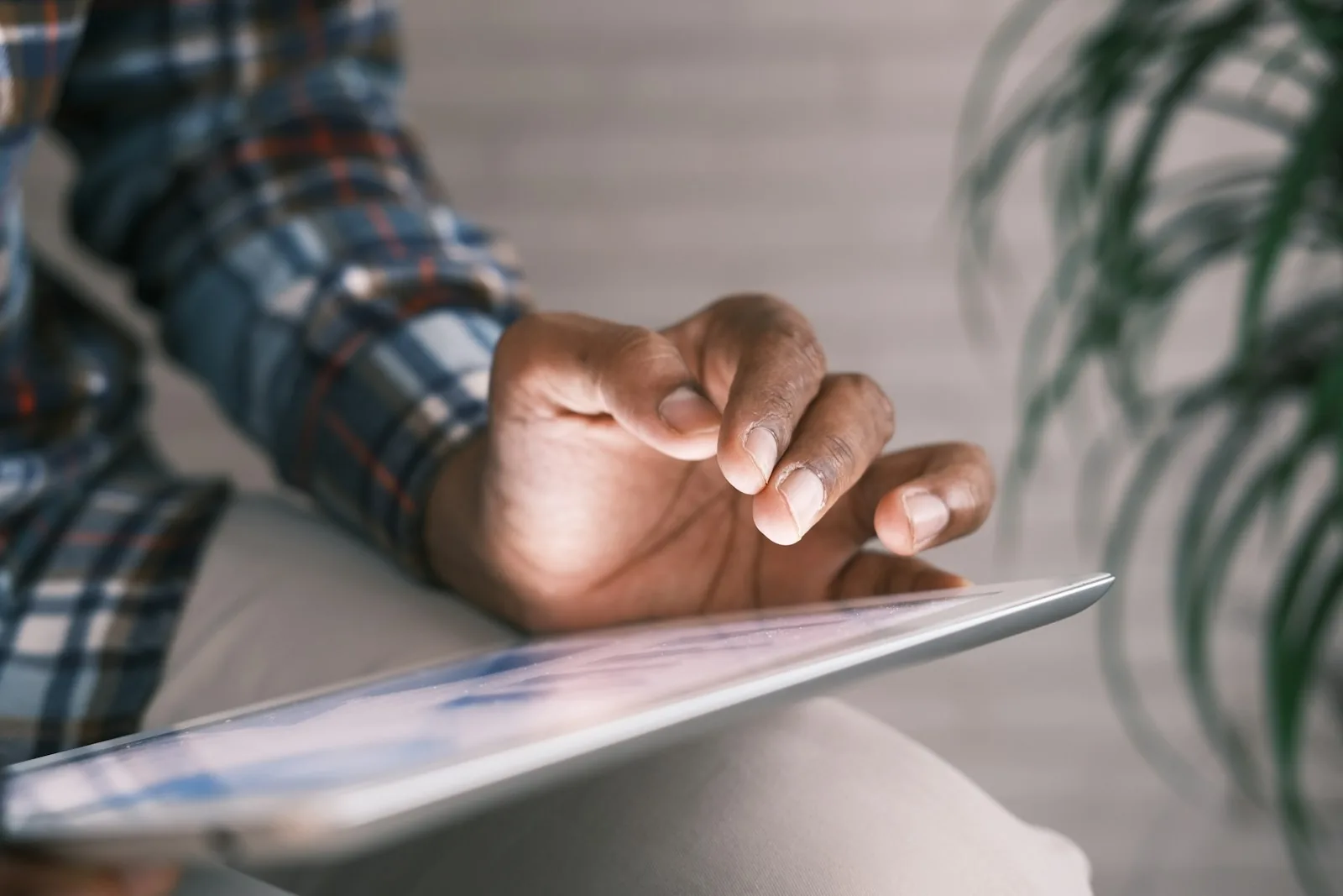 person using tablet on couch