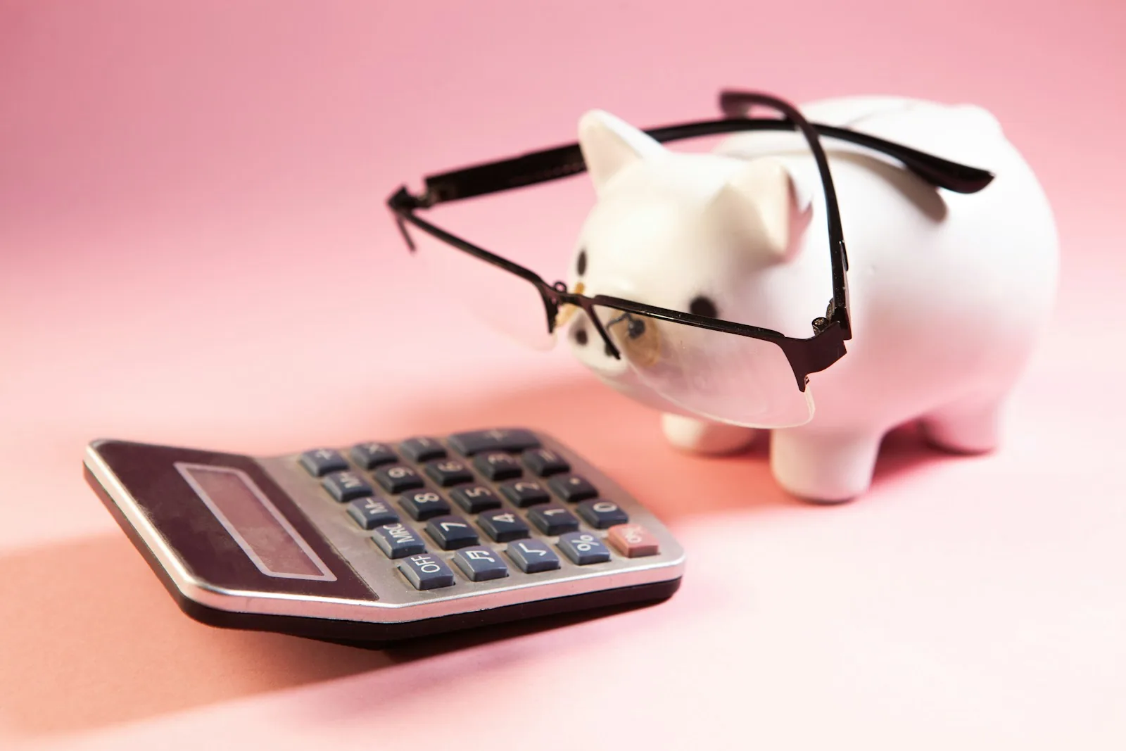 piggy bank with coins and calculator