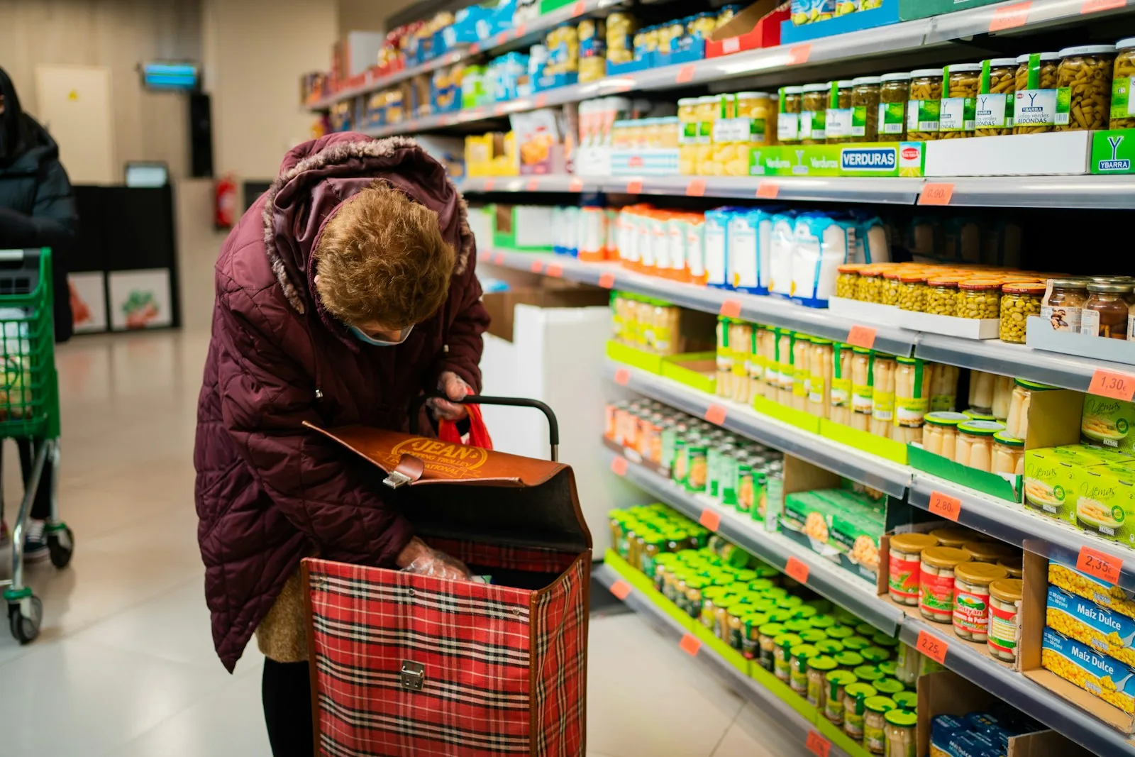 shoppers comparing grocery prices checkout